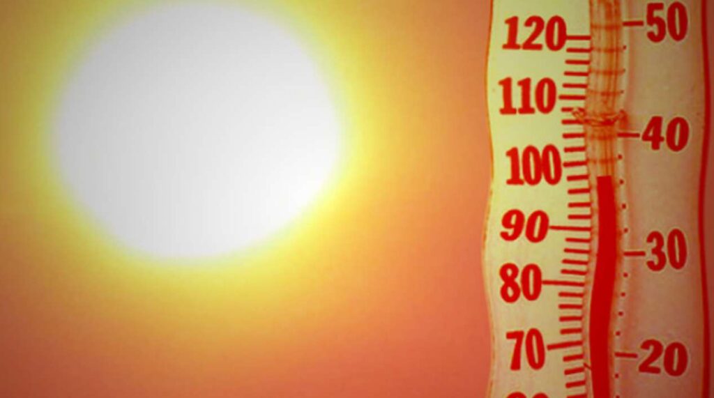 Thermometer showing high temperature under sun.